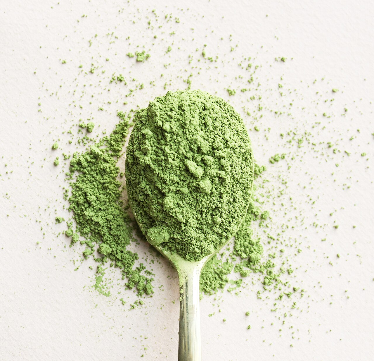 Finely milled green tea powder on a spoon