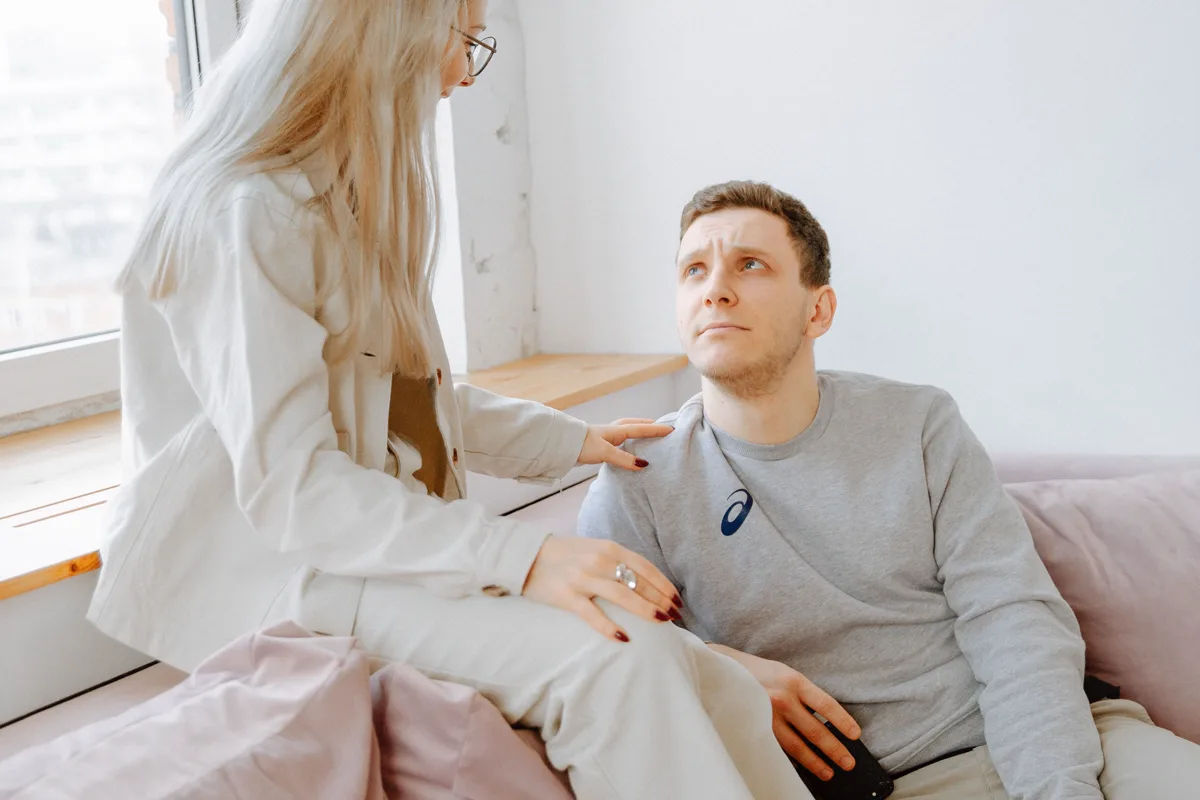 Couple having a serious face-to-face conversation at home