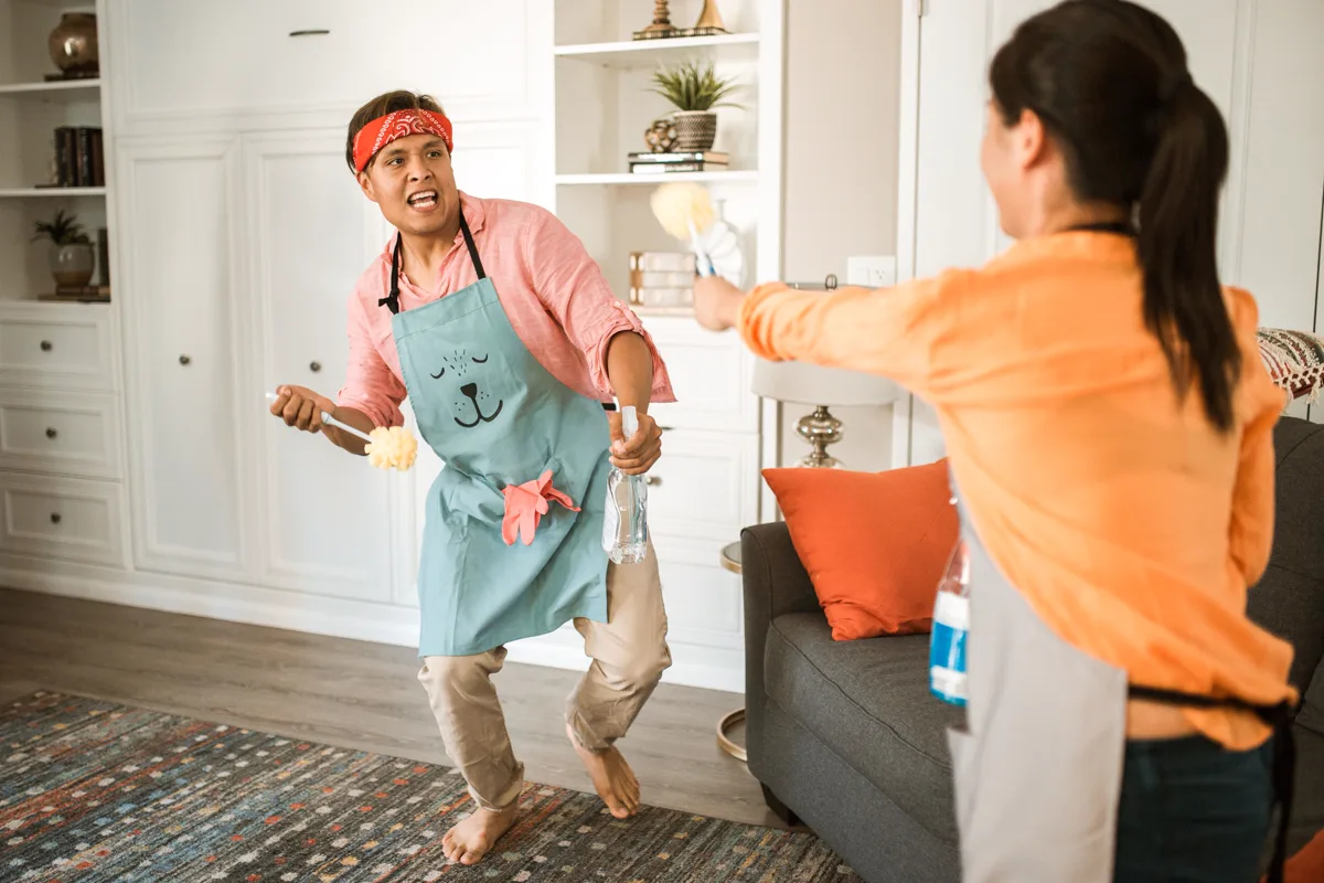 Couple sharing household cleaning together