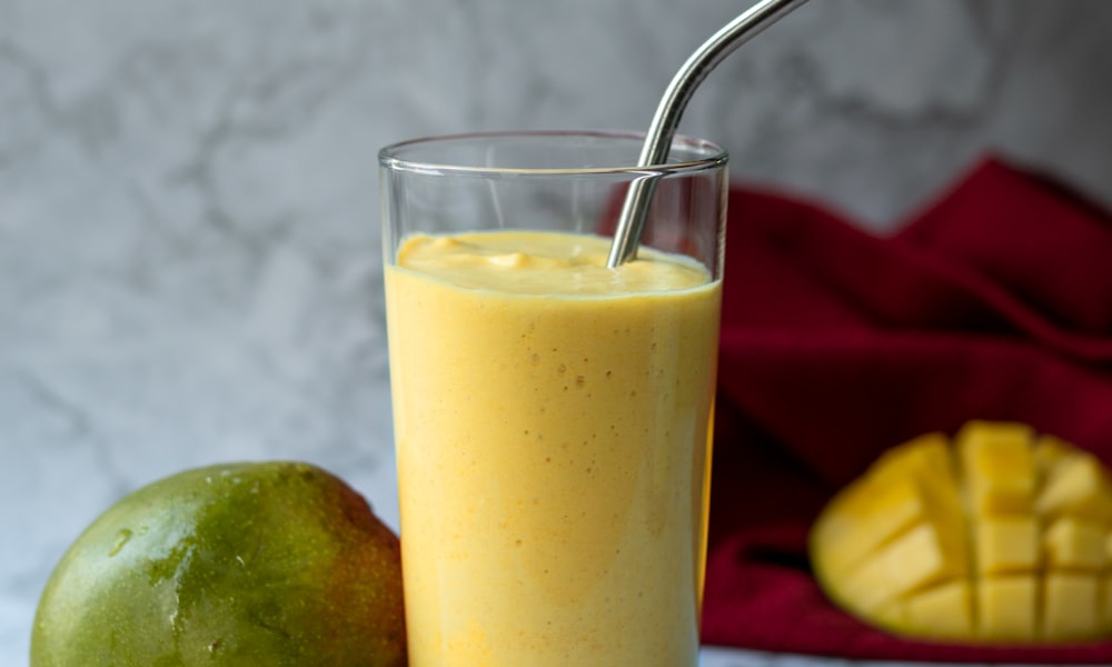 Creamy mango banana smoothie poured into a glass