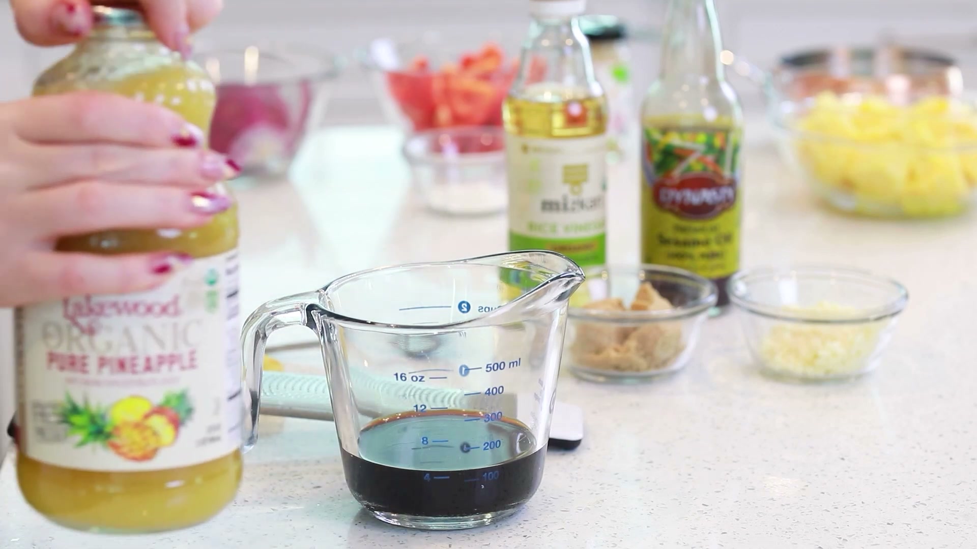 Whisking homemade teriyaki marinade in a glass bowl