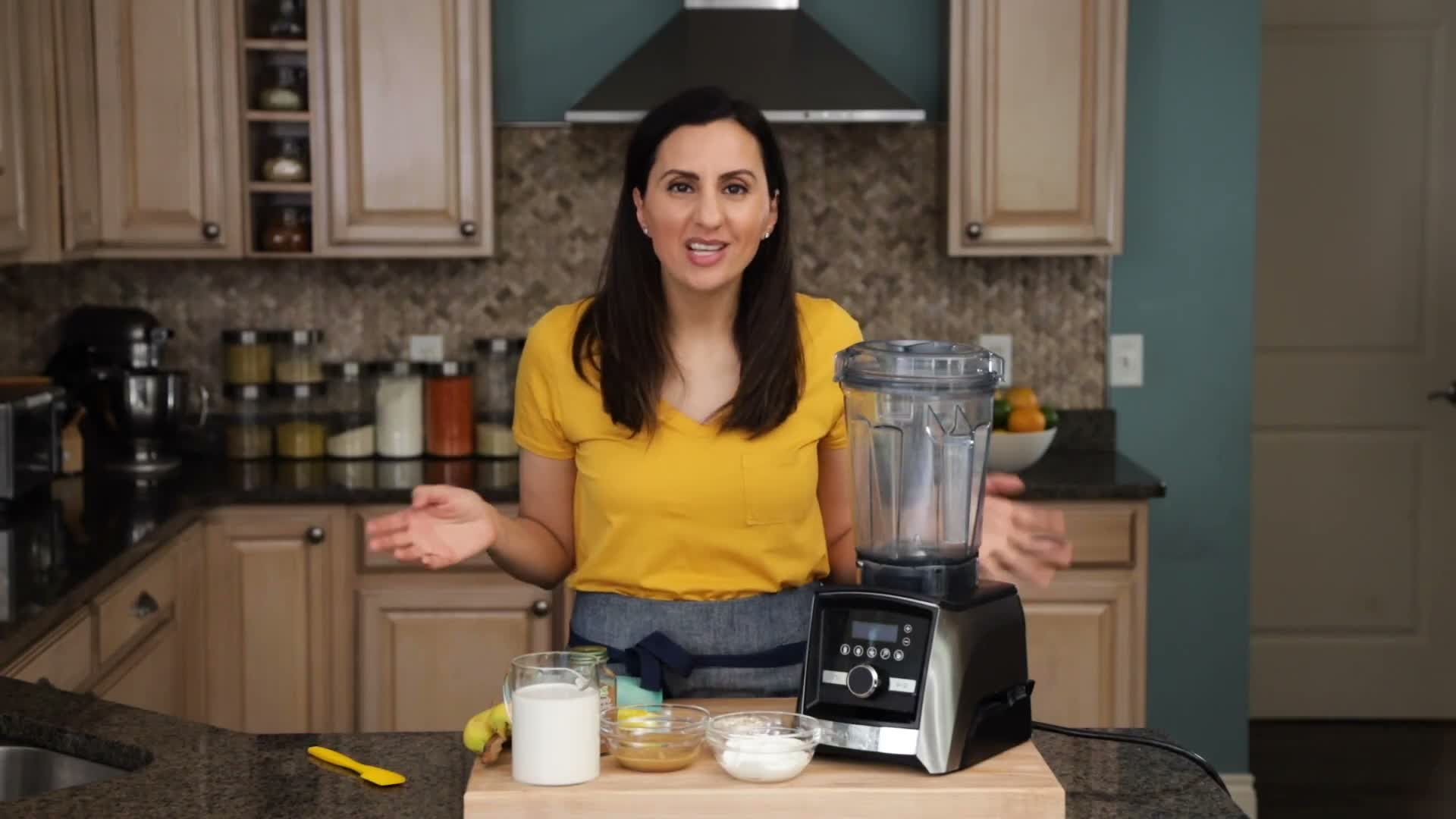 Peanut butter banana smoothie ingredients set beside a blender