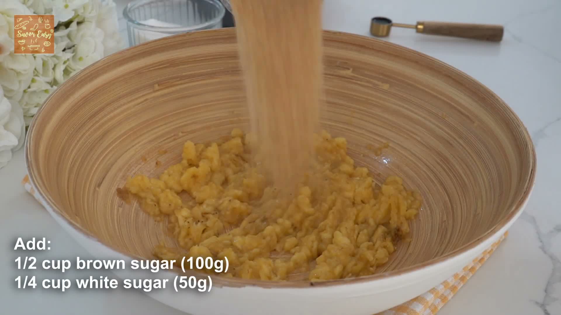 Mixing mashed bananas and brown butter batter